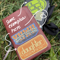 Brown leather Bible with text and stickers on a grassy background